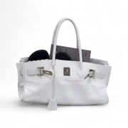 White handbag with silver hardware on a